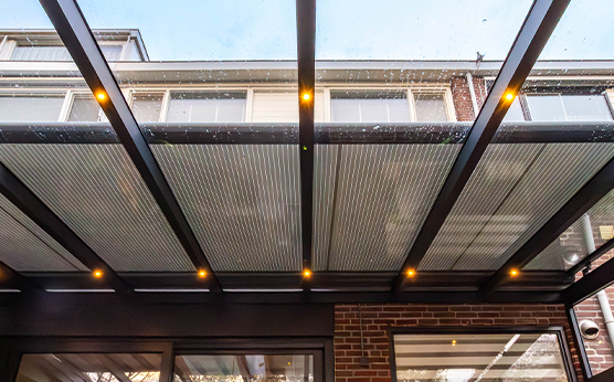Bovendakzonwering op overkapping met glazen dak – Van Beem Buitenleven