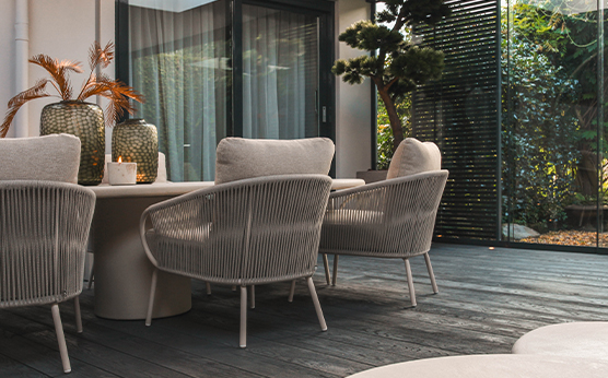 Suns Dolce low dining chair with concrete table – modern low dining arrangement – Van Beem Outdoor Living