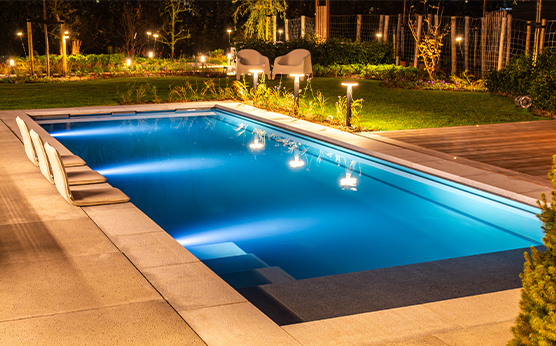 Built-in monoblock swimming pool in garden during evening – luxurious water experience – Van Beem Buitenleven