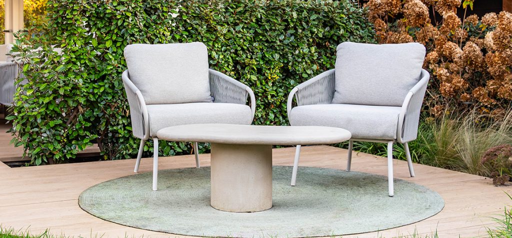 Suns lounge chairs with a concrete-look table for a luxurious garden and patio